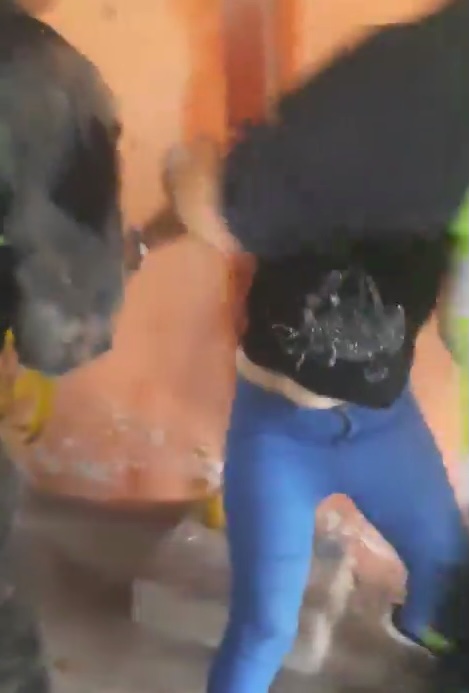 A woman being arrested by police.