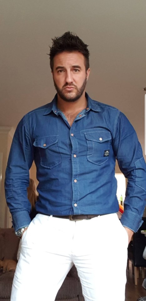 Man in a denim shirt and white pants.
