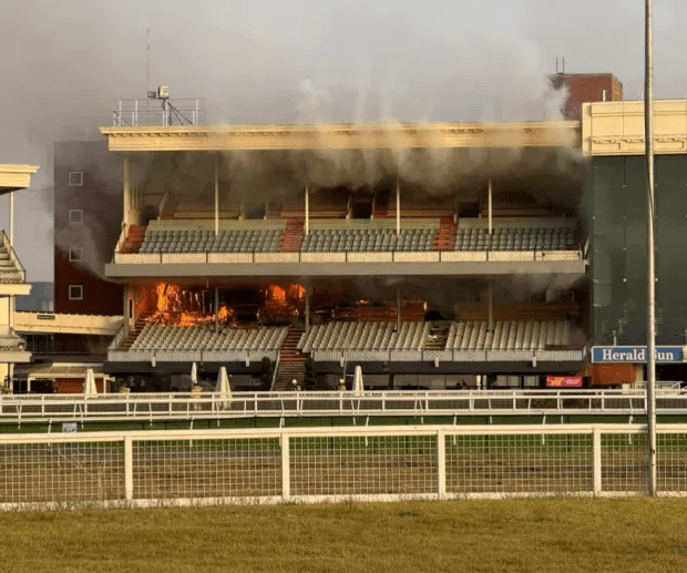 Racecourse grandstand on fire.