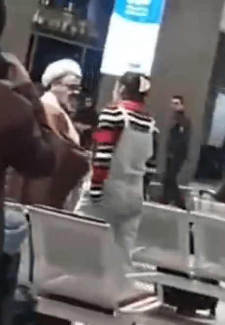 People waiting in an airport terminal.