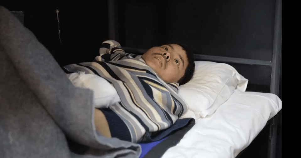 Man lying in bed looking upward.