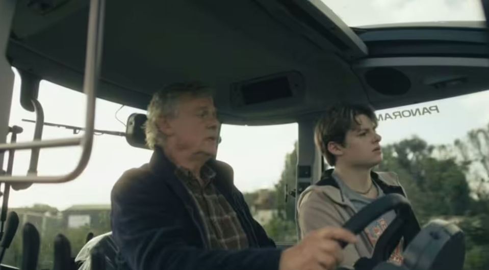 Two men in a tractor.