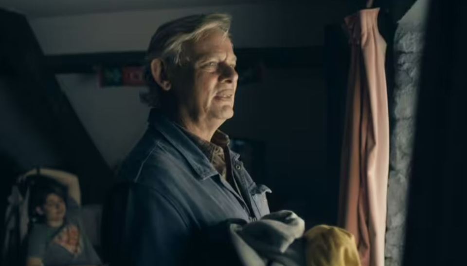 A man looking out a window.