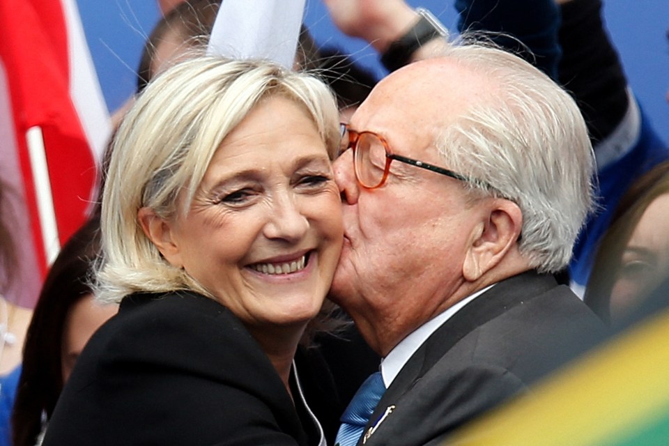Jean-Marie Le Pen kissing his daughter Marine Le Pen on the cheek.