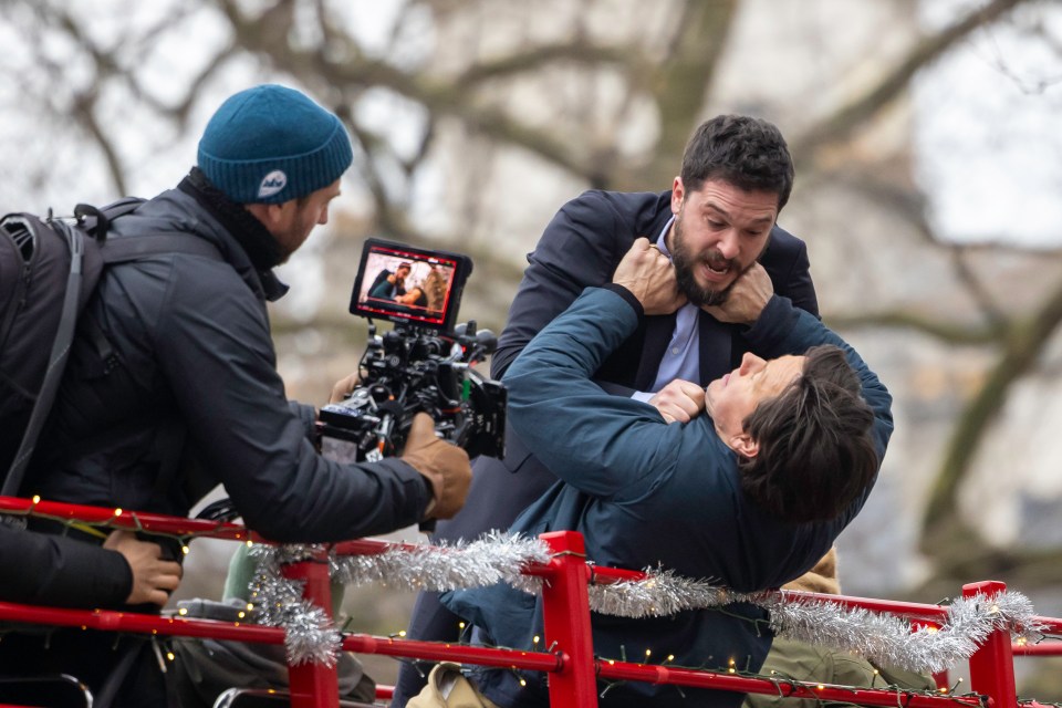 Behind-the-scenes shot of Mark Wahlberg, Kit Harington, and Michelle Monaghan filming a scene for "The Family Plan 2".