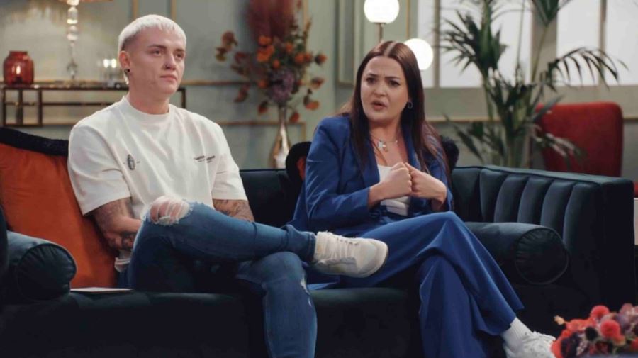 Charlie from Married at First Sight sits on a couch with a man.