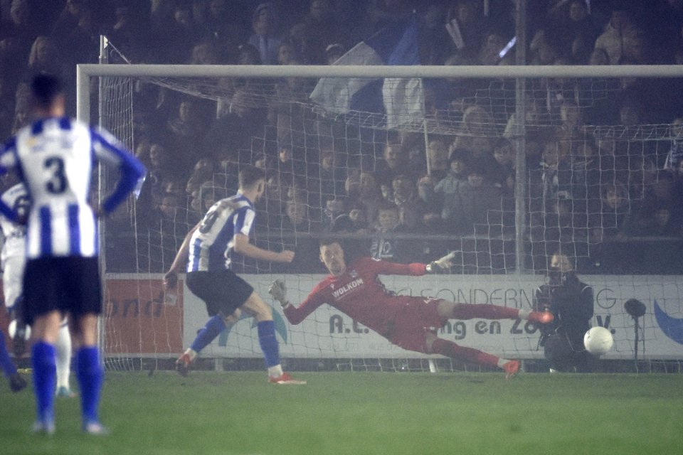 Soccer goalie diving to block a penalty kick.