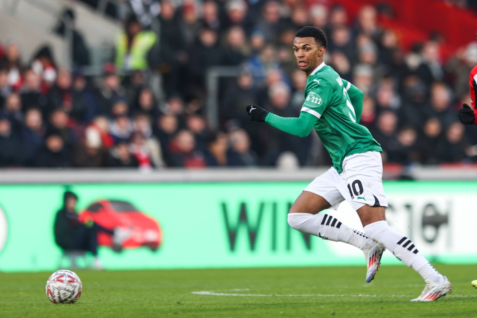 Soccer player Morgan Whittaker of Plymouth Argyle running with the ball.