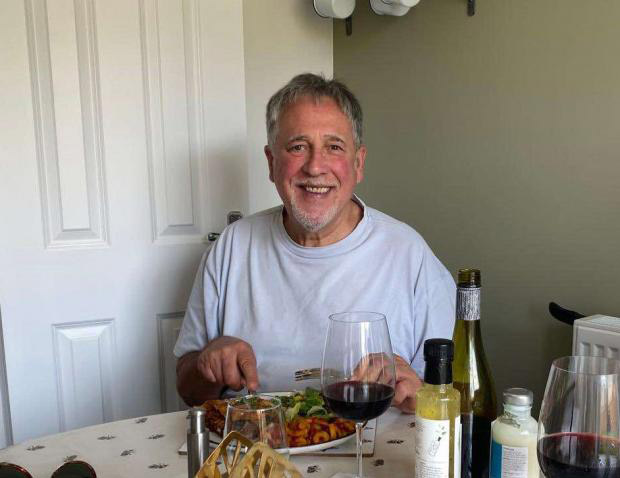 Man sitting at a table eating a meal.