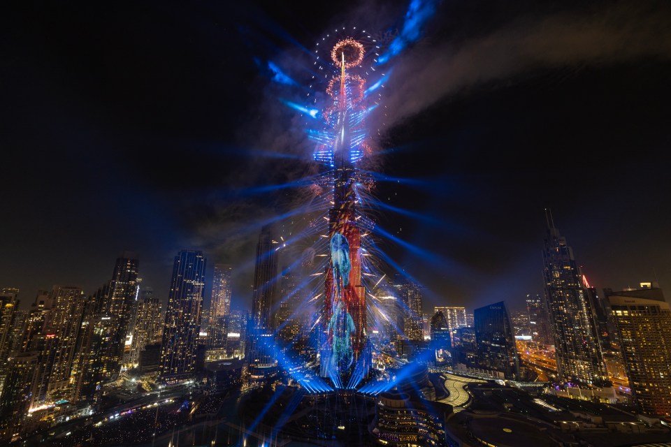 Fireworks exploding around the Burj Khalifa tower.