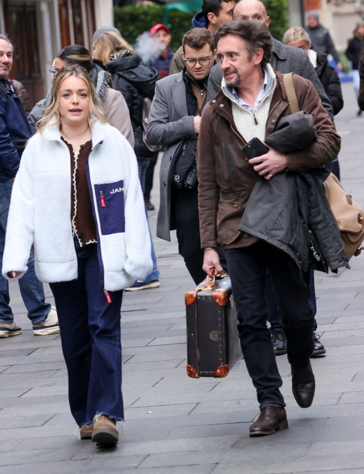 Richard Hammond walking with his daughter and a suitcase.