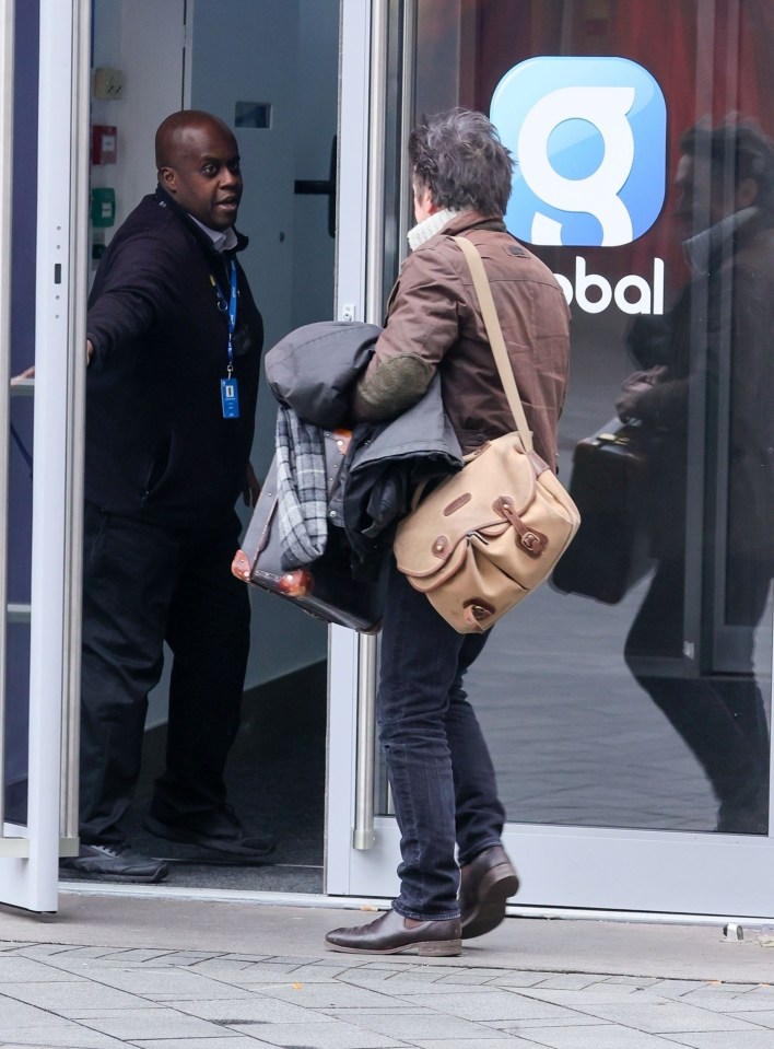 Richard Hammond leaving Global offices with a suitcase.