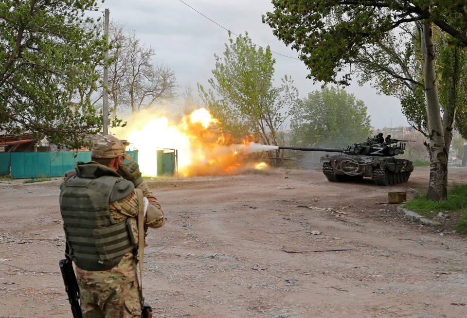 Pro-Russian troops firing a tank in Mariupol, Ukraine.