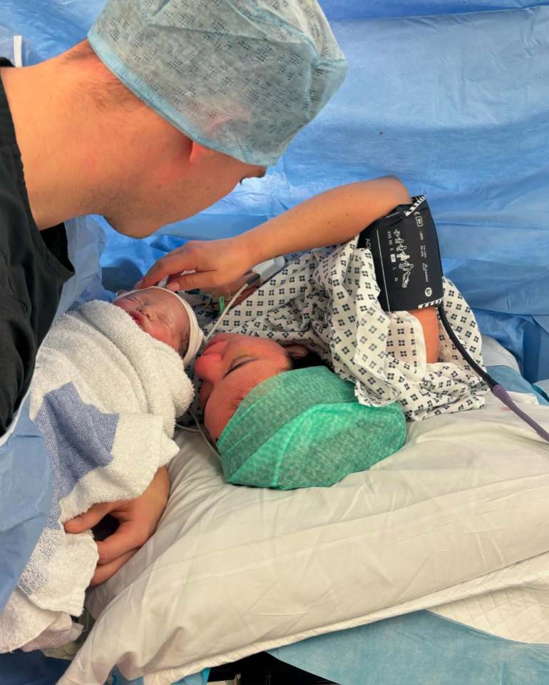 New parents gazing at their newborn baby.