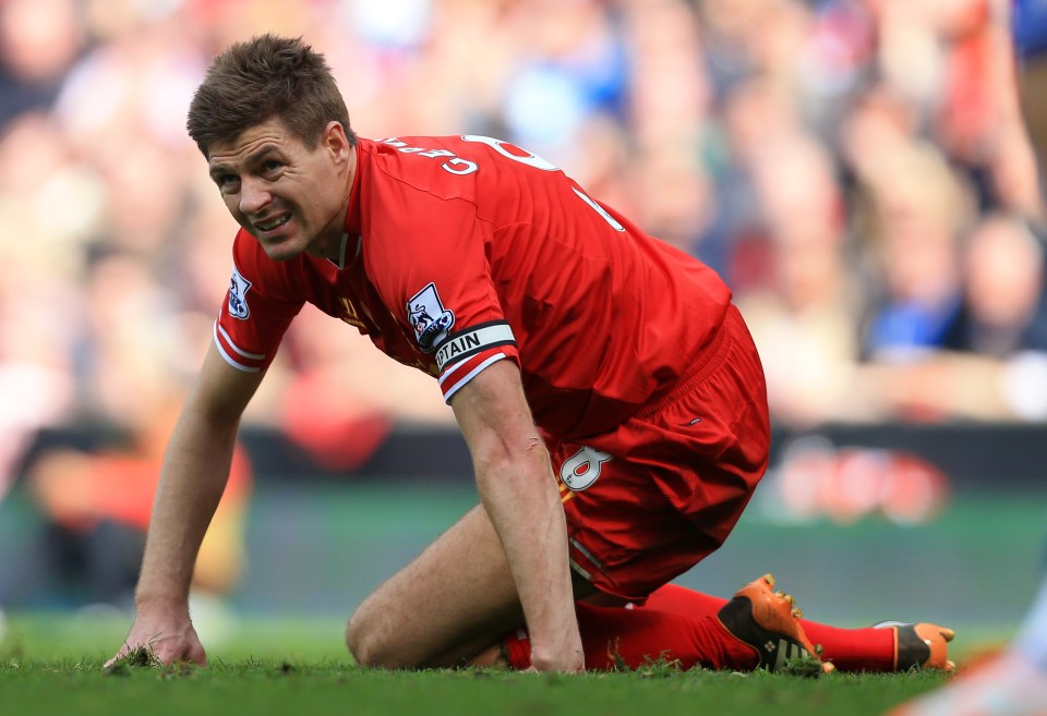 Steven Gerrard of Liverpool kneeling on the field looking dejected.