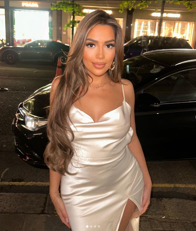 Woman in a cream slip dress.