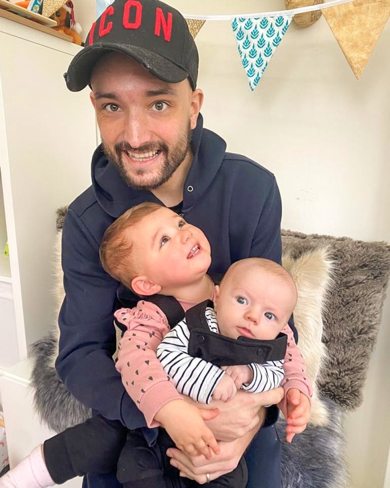 Man holding two babies.