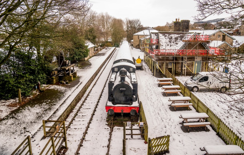 A snow-covered train at a station.