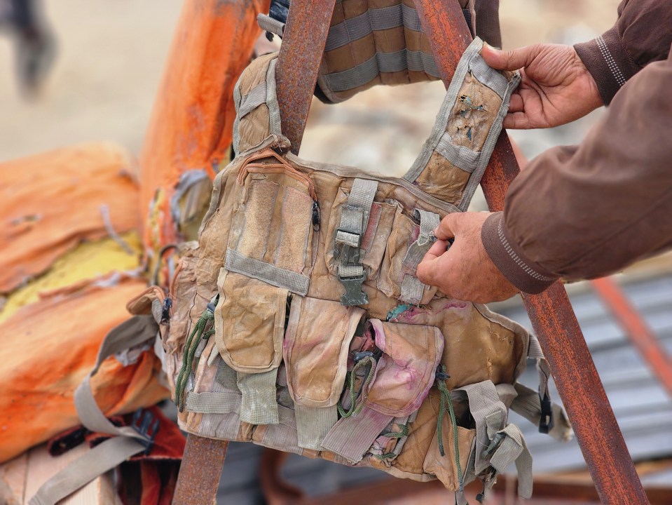 A damaged military vest found in the debris of a building.