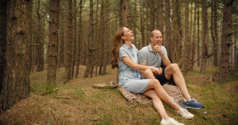 The Prince and Princess of Wales laughing together in a forest.