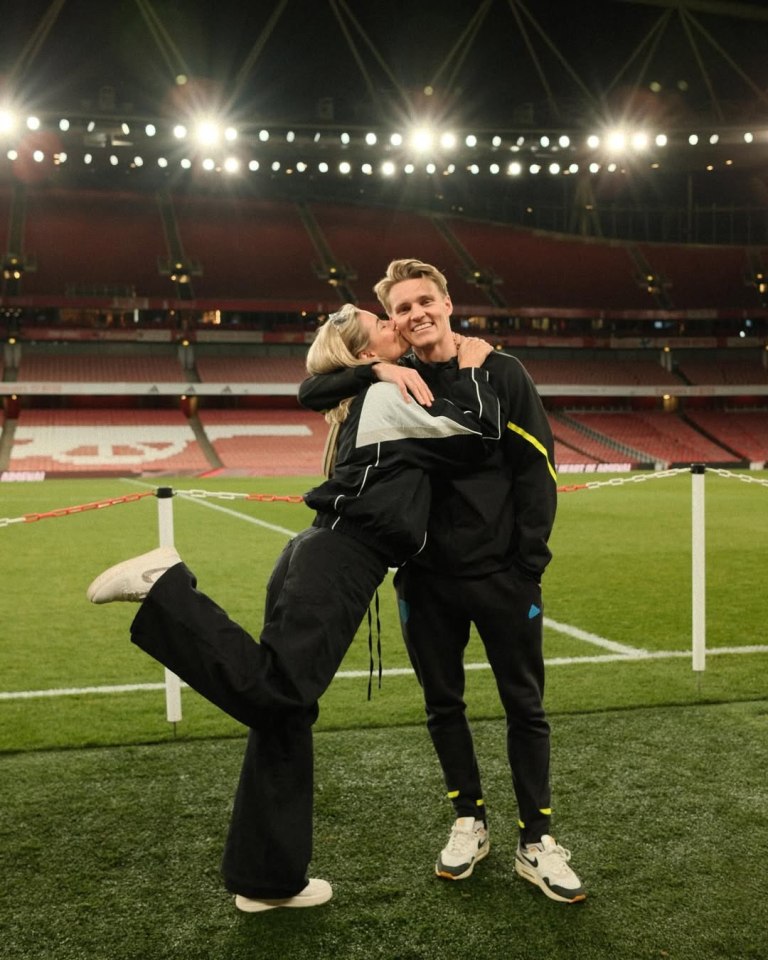 Couple embracing on a soccer field.