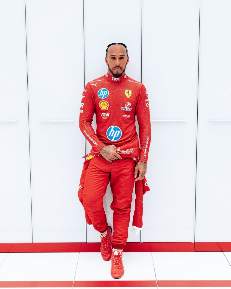 Lewis Hamilton in a red racing suit.