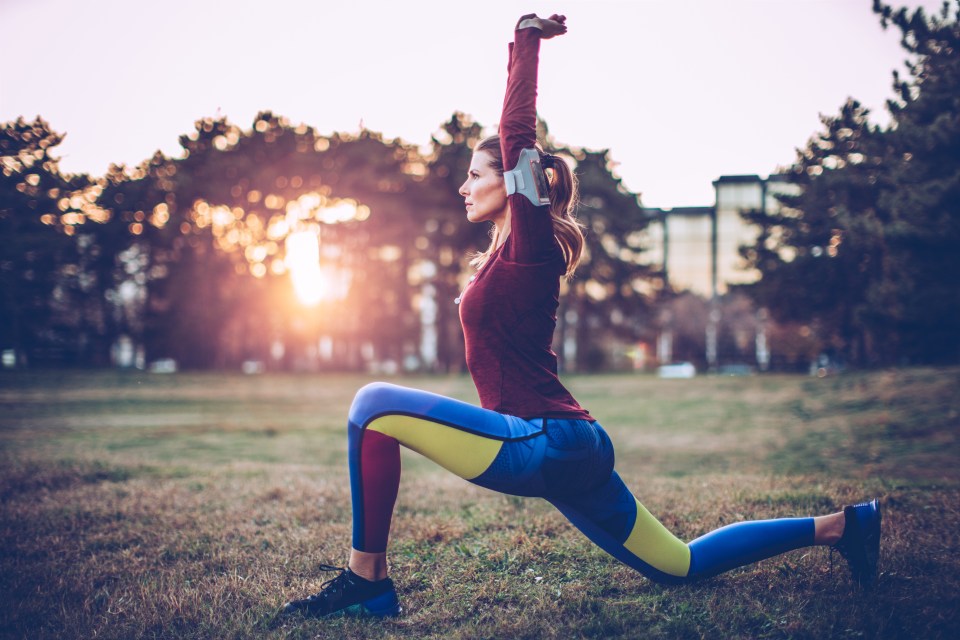 Woman stretching in a park before a jog.