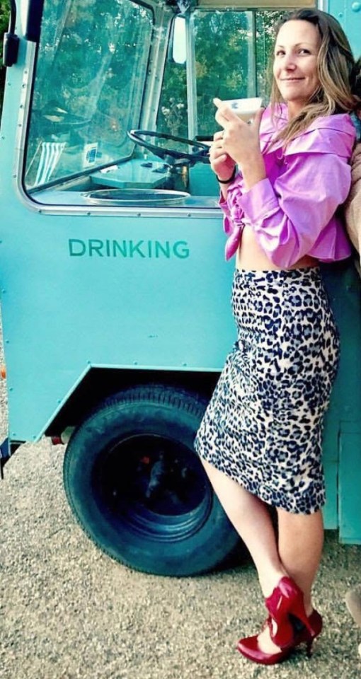 Woman in leopard print skirt standing by a teal mobile bar.