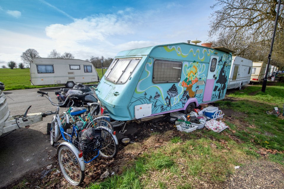Caravans parked on grass with painted caravan and bicycles.