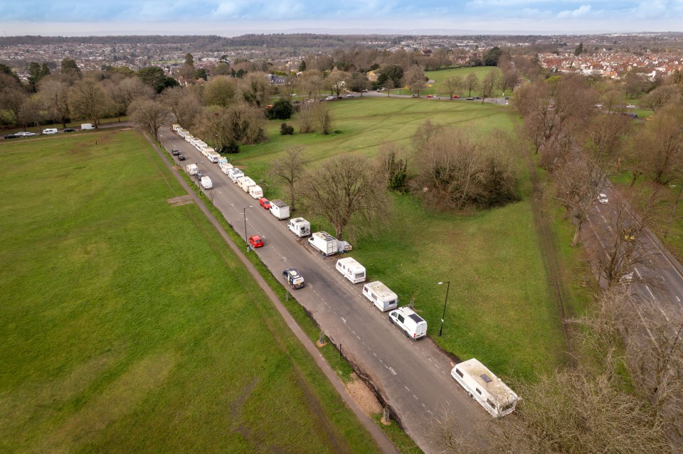 Aerial view of caravans parked along a road in a park.