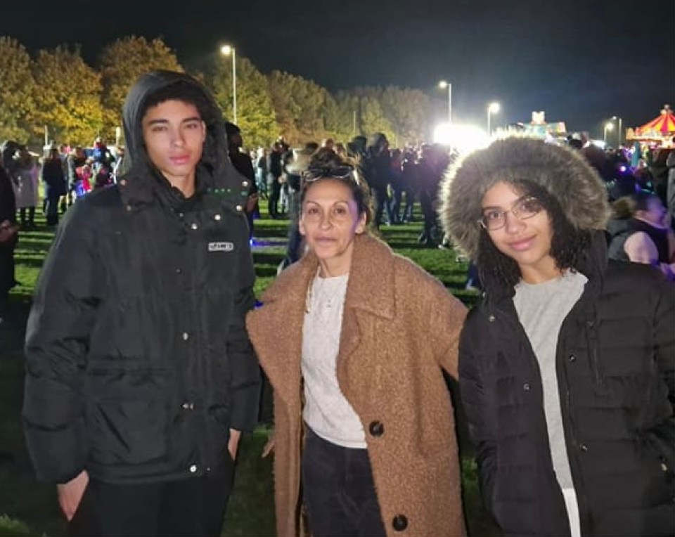 Photo of a mother and her two children at night.
