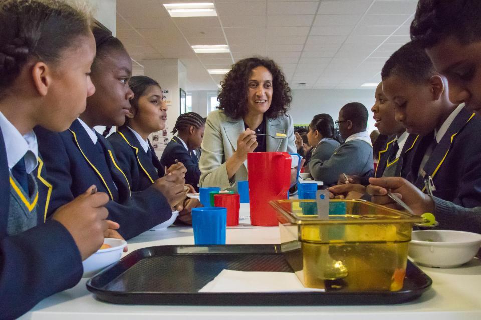 Mayor Boris Johnson chats with students during brunch at a school.