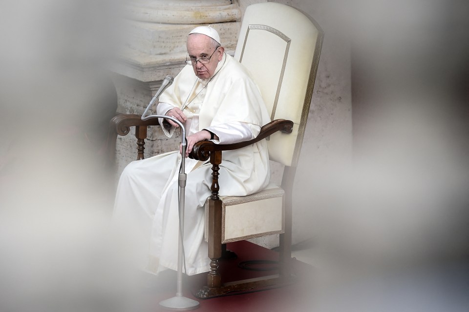 Pope Francis seated in a chair.