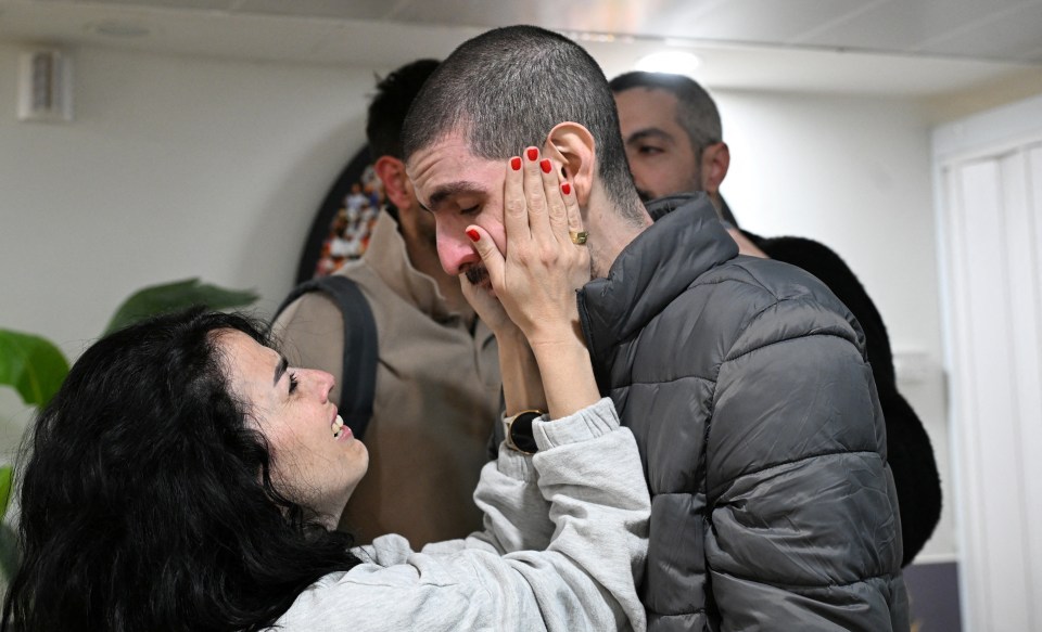Released hostage embracing loved one.