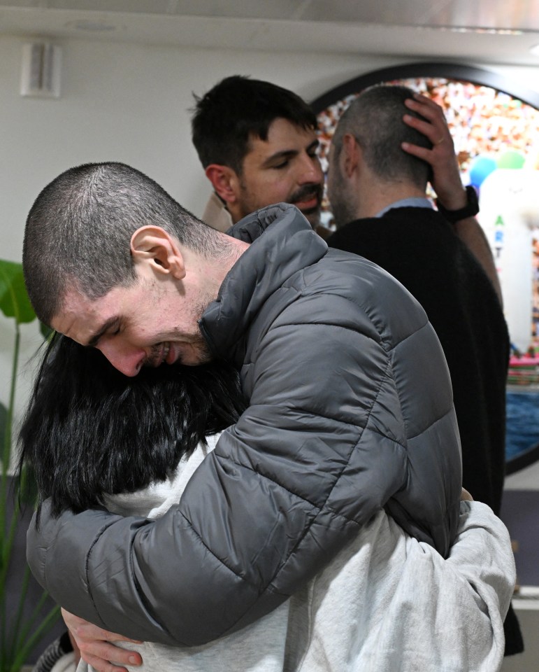 Released hostage embracing loved one.