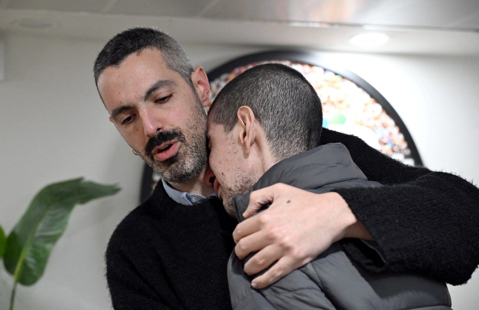 Released hostage embracing loved one.