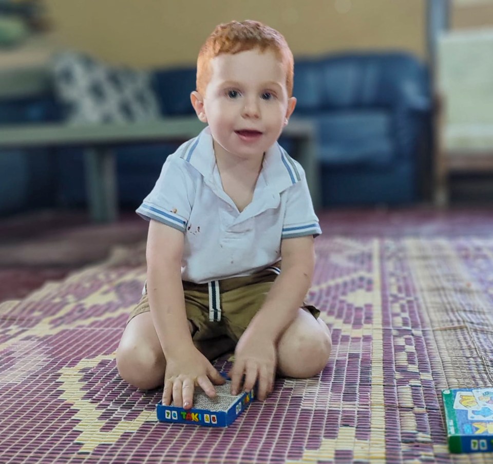 Young boy playing with a game.