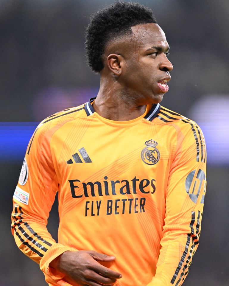 Vinicius Junior of Real Madrid in an orange jersey.