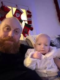 A father and his young daughter.