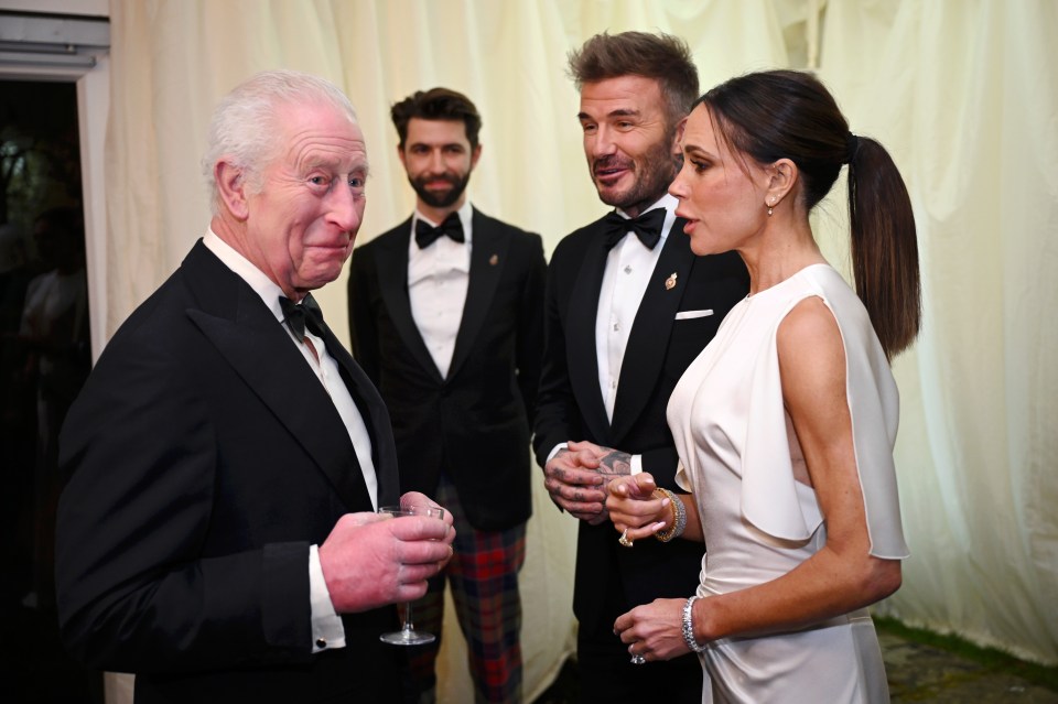 King Charles III speaking with David and Victoria Beckham.