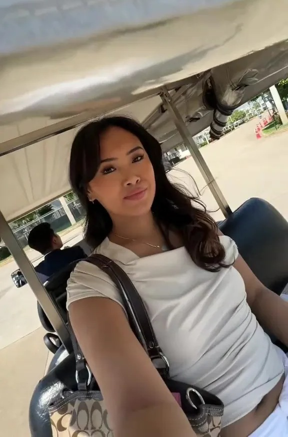 Woman in a golf cart.