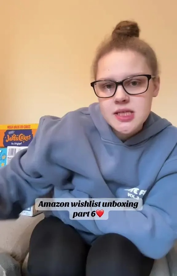 Woman unboxing Amazon wishlist items.