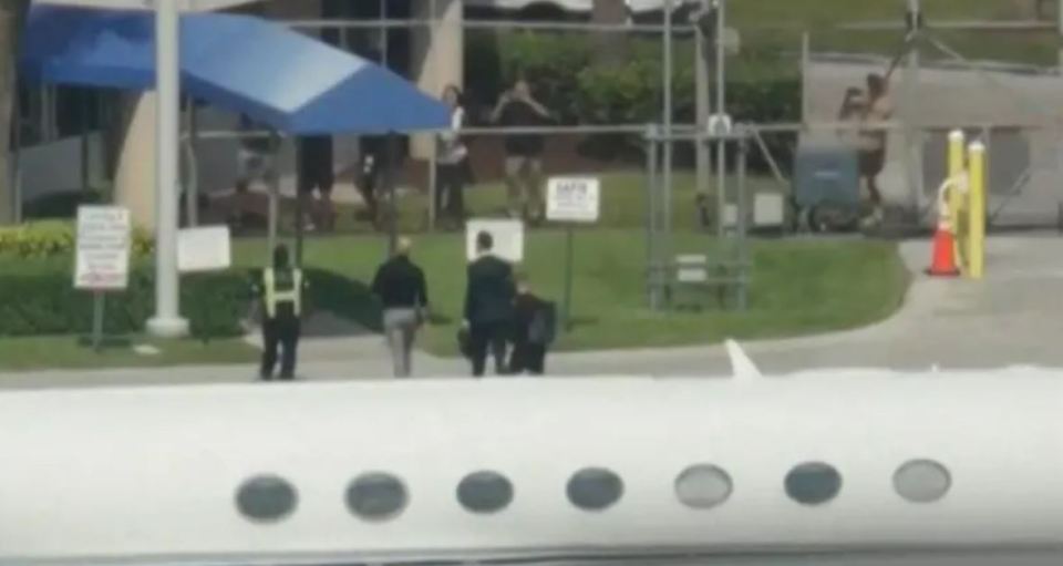 Andrew and Tristan Tate leaving a plane at Fort Lauderdale-Hollywood International Airport.