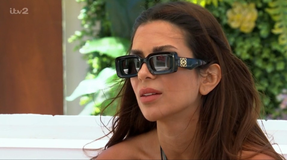 Screenshot of a woman wearing sunglasses.