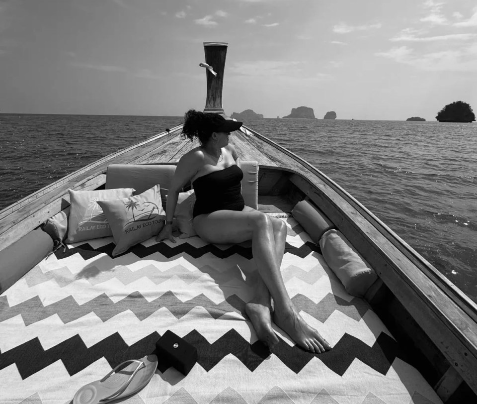 Woman in swimsuit relaxing on a boat.