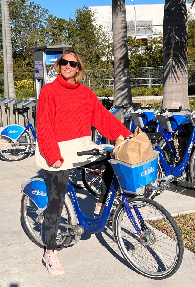 Woman smiling while riding a Citi Bike.