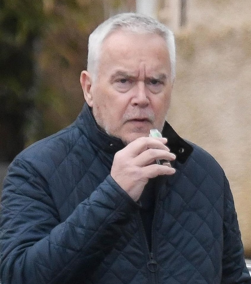 Huw Edwards and his mother walking together.