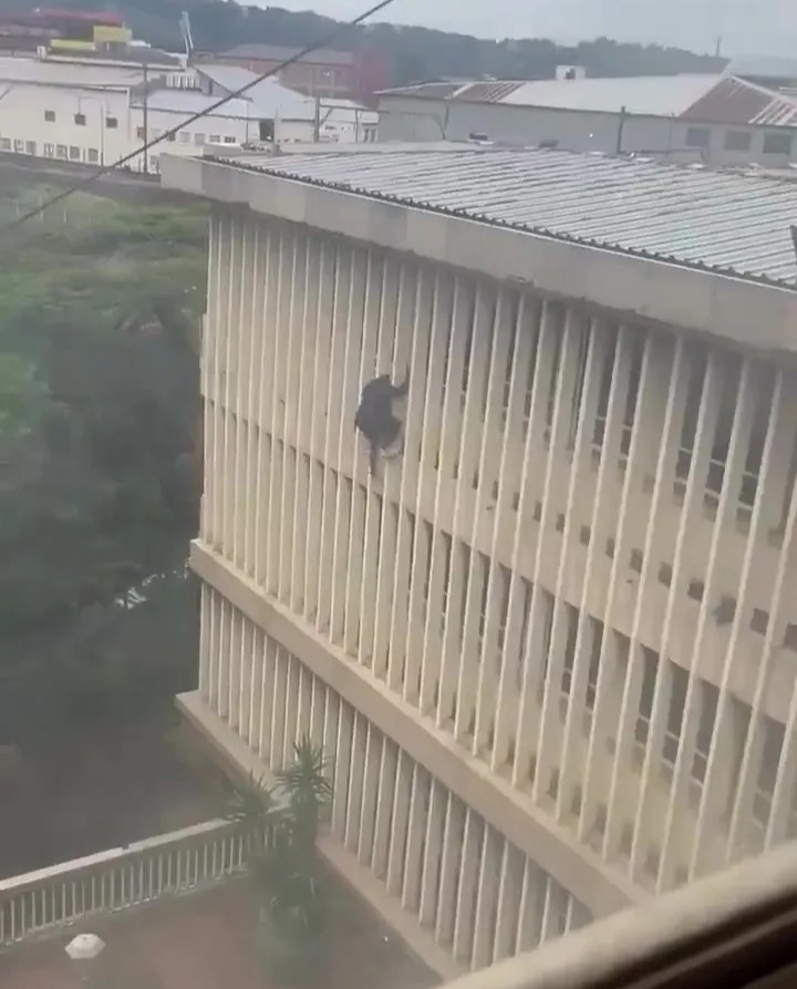 Man escaping from a courthouse window.