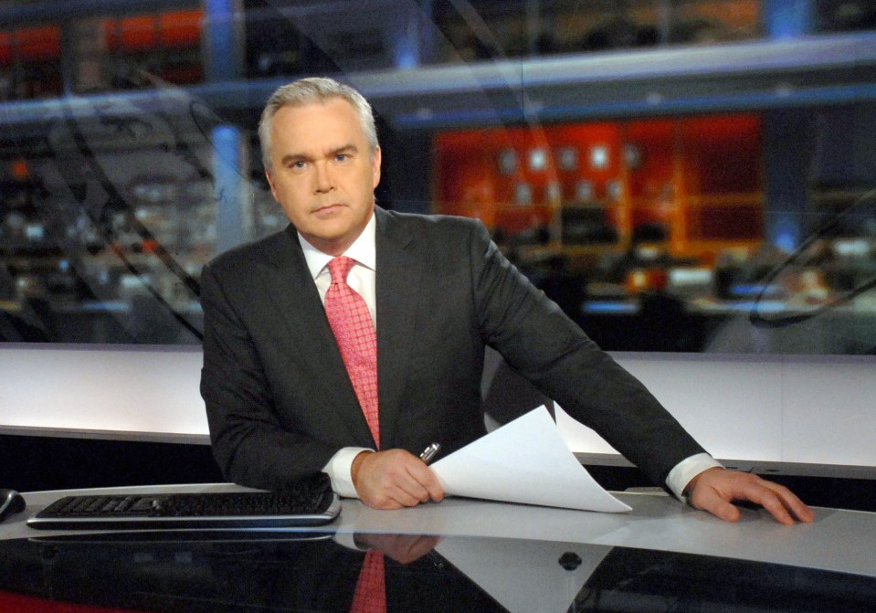 News anchor at a news desk.