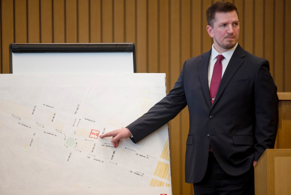 Prosecutor presenting a crime scene map during a trial.